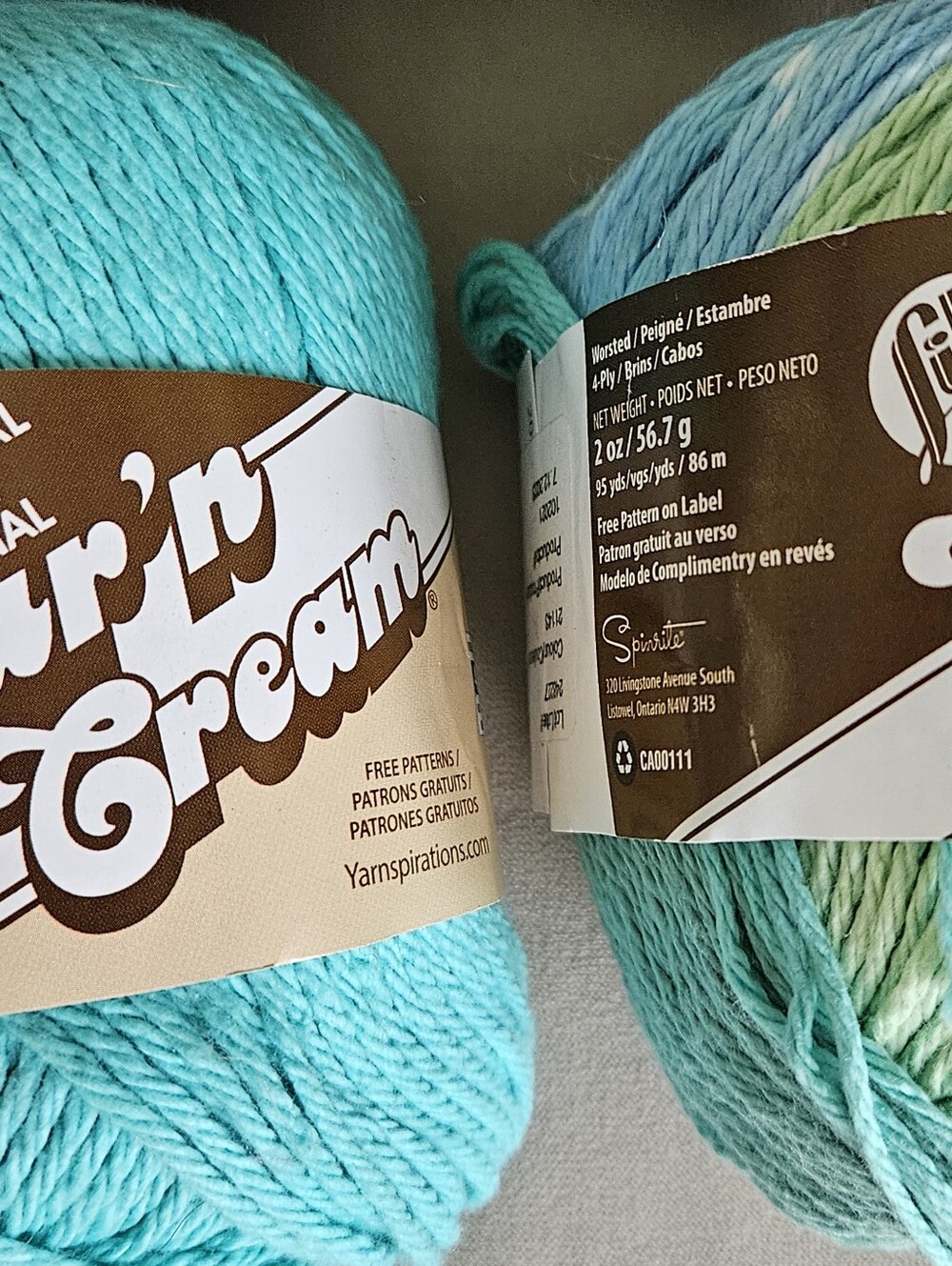 Nine skeins of yarn. Various colors of 3 brands.